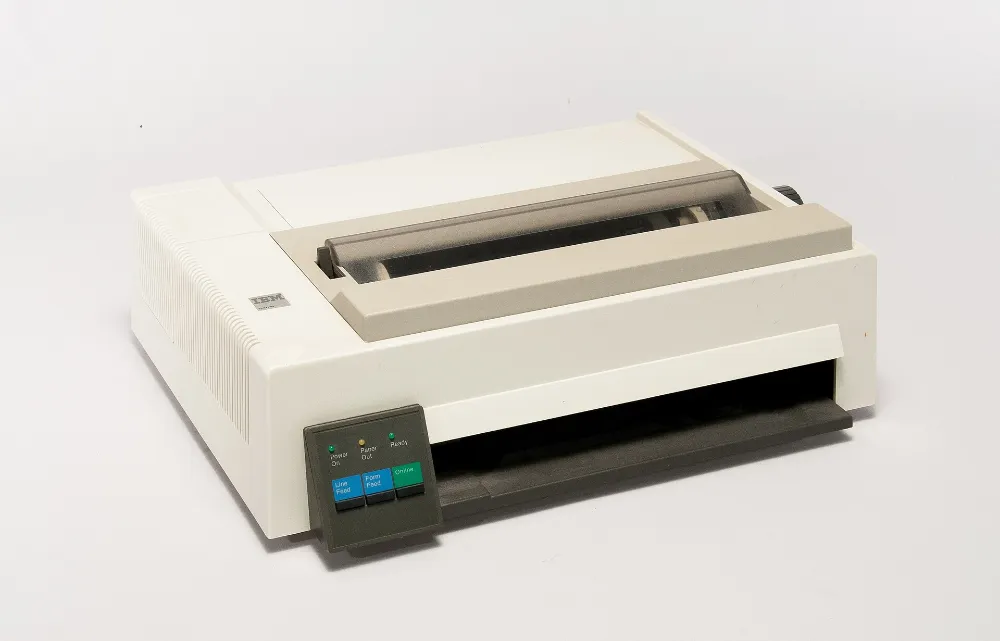 A cream-coloured IBM Proprinter dot-matrix printer from the 1980s