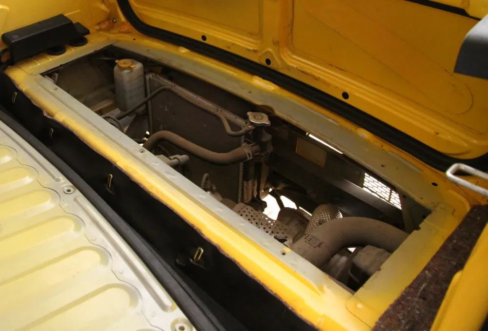 The Tata Nano's small engine, seen through an opening at the back of the car